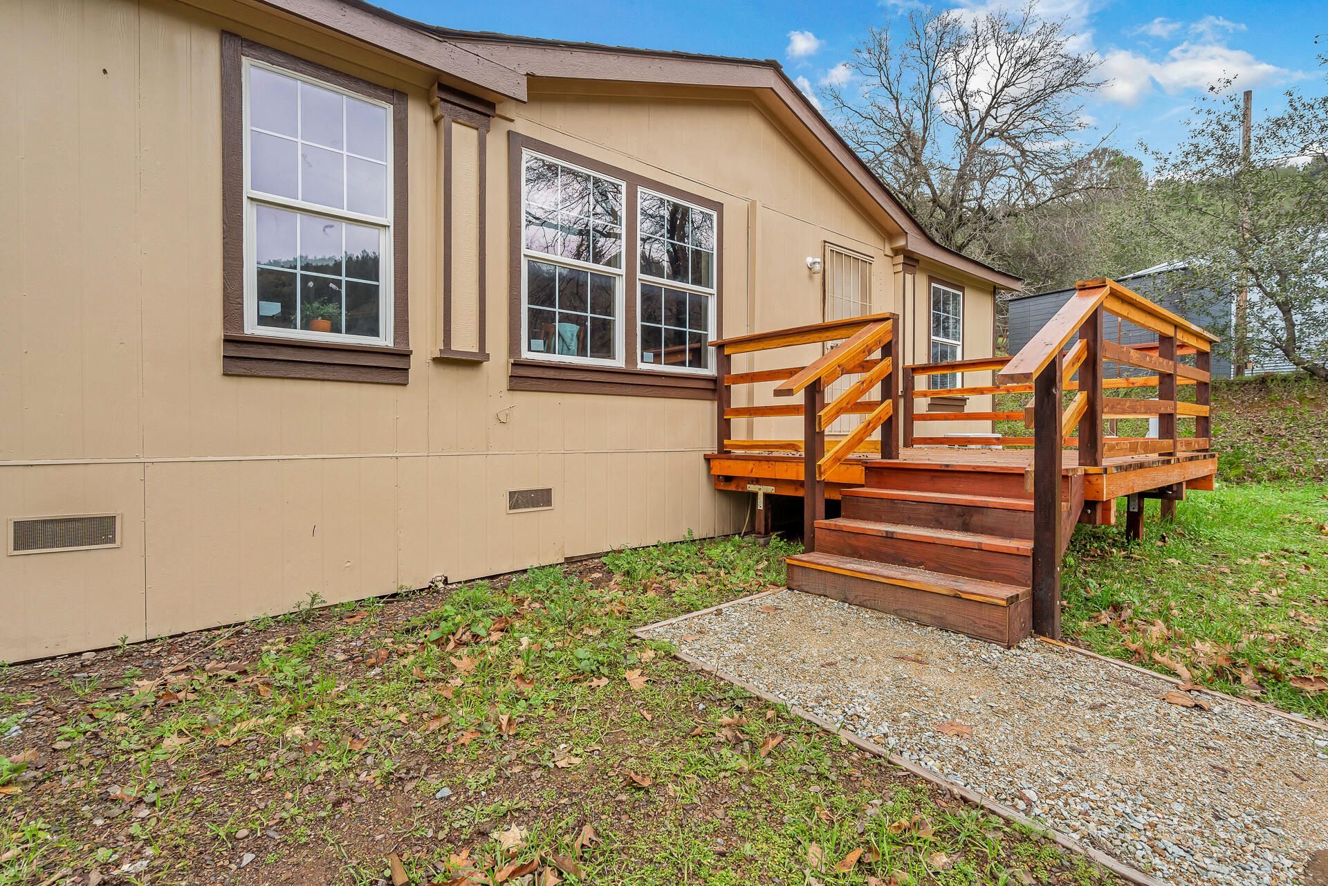 22150 Ravine Court Redding, CA 96003 - Photo 35 of 37 a backyard of a house with wooden fence and a bench