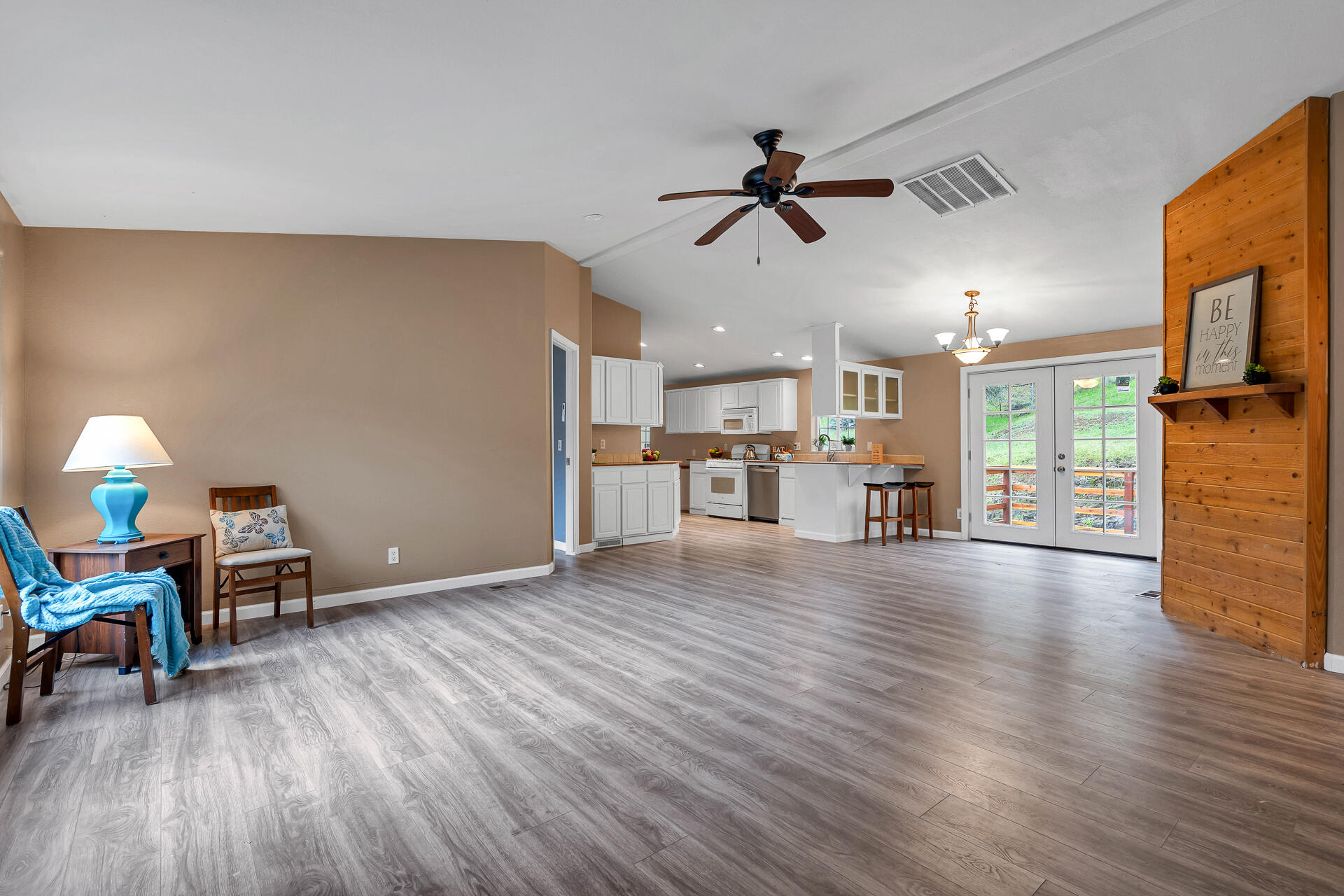 22150 Ravine Court Redding, CA 96003 - Photo 6 of 37 a view of a livingroom with furniture hardwood floor a ceiling fan and windows