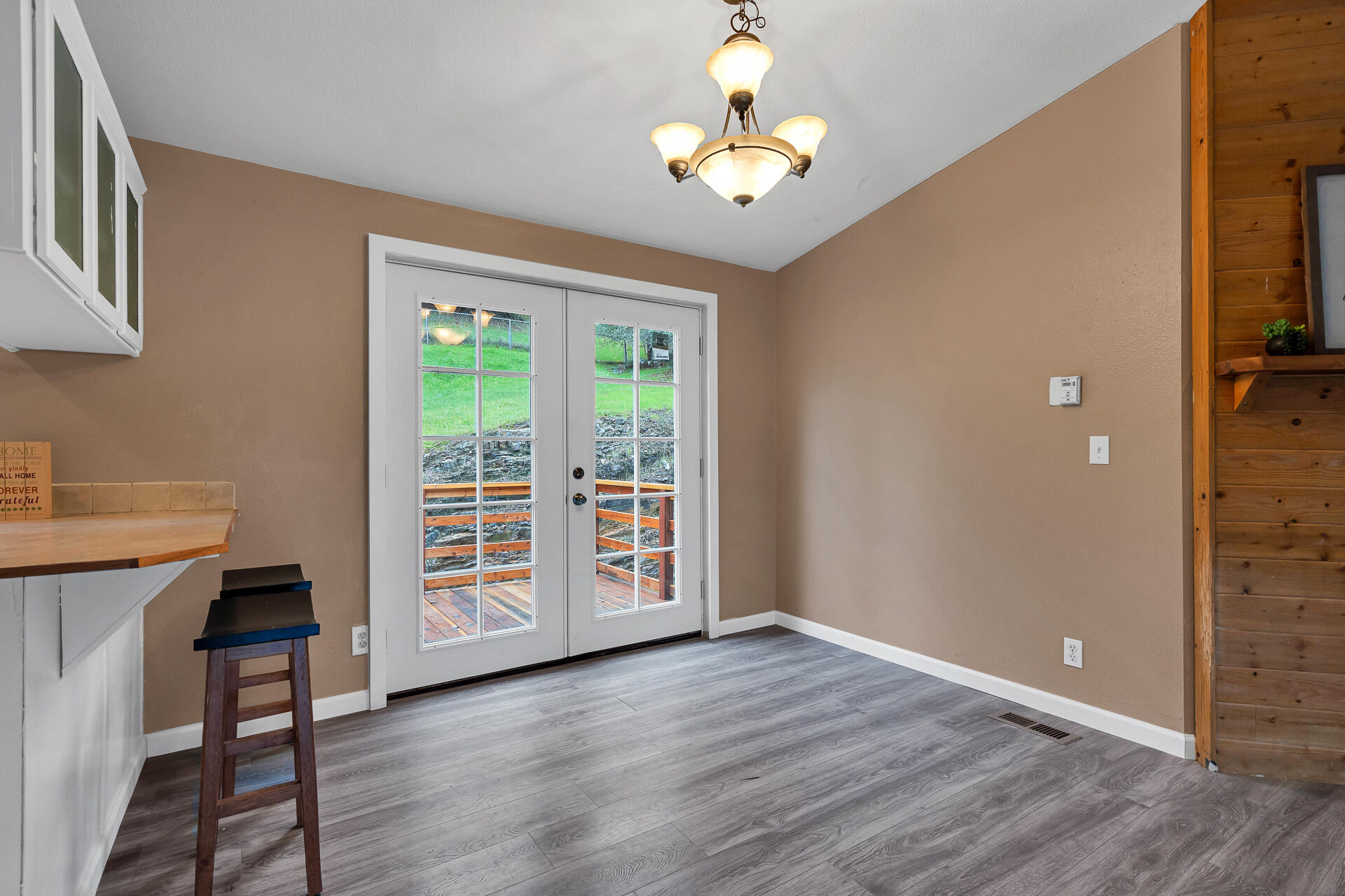 22150 Ravine Court Redding, CA 96003 - Photo 8 of 37 an empty room with wooden floor cabinet and windows