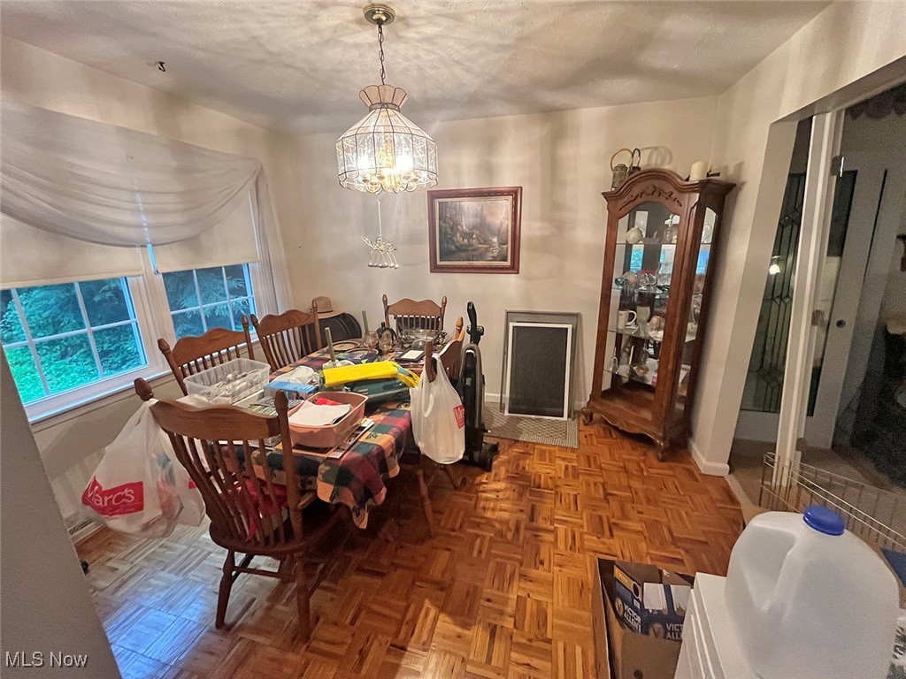 4380 Harner Road Mantua, OH 44255 - Photo 9 of 19 Dining room with baseboards and a chandelier