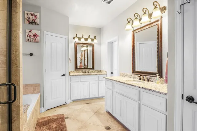a bathroom with a tub shower and a window