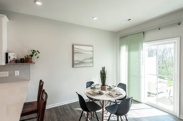 a dining room with furniture and window