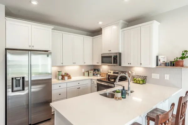a kitchen with a sink a stove and refrigerator