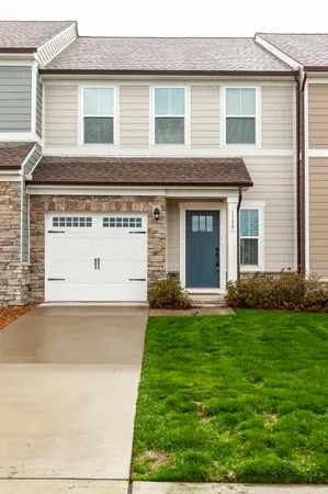 a view of a house with a yard and garage