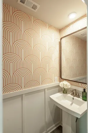 a bathroom with a sink a mirror and a shower curtain