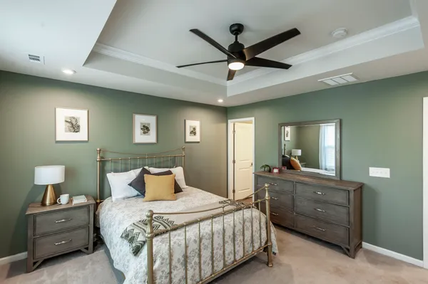 a bedroom with a bed and a chandelier