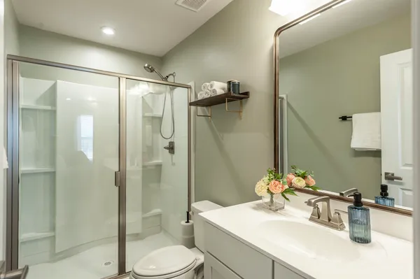 a bathroom with a sink toilet and shower
