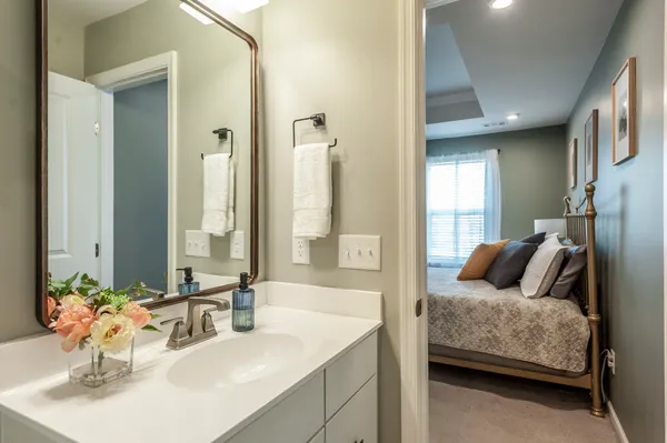 a bathroom with a granite countertop sink and a mirror