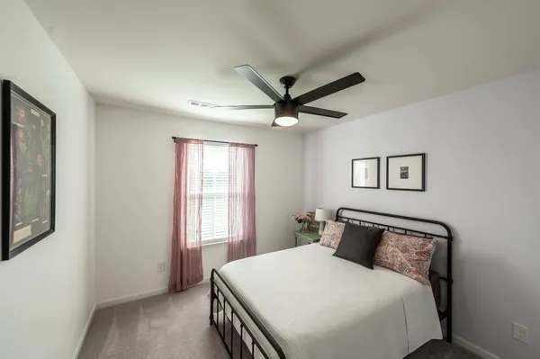 a bedroom with a large bed and a large window