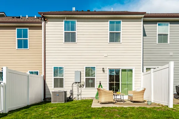 a front view of a house with a yard table and chairs