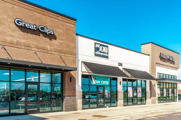 a front view of a building with parking space