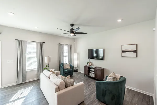 a living room with furniture and a flat screen tv