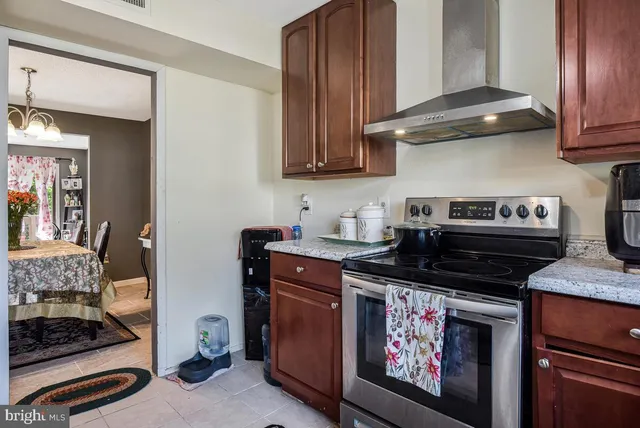 a kitchen with stainless steel appliances granite countertop a stove and a microwave