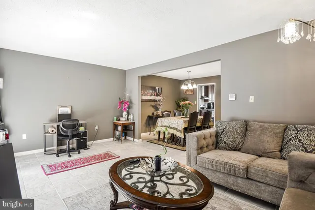 a living room with furniture and a dining table