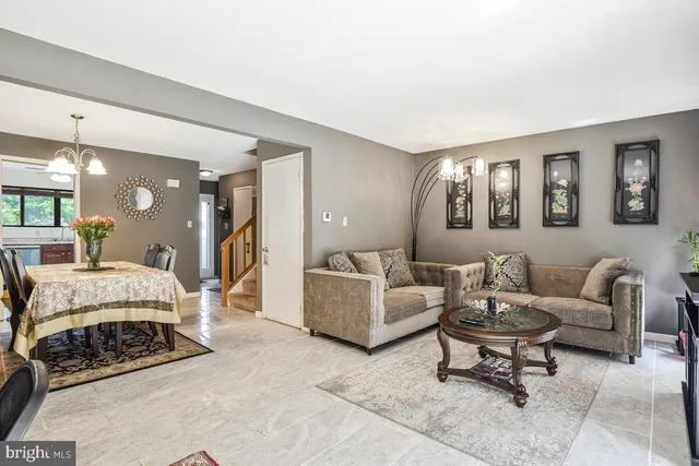 a spacious bedroom with a bed a couch and a view of en suite bathroom