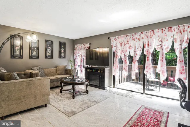 a living room with furniture and a floor to ceiling window