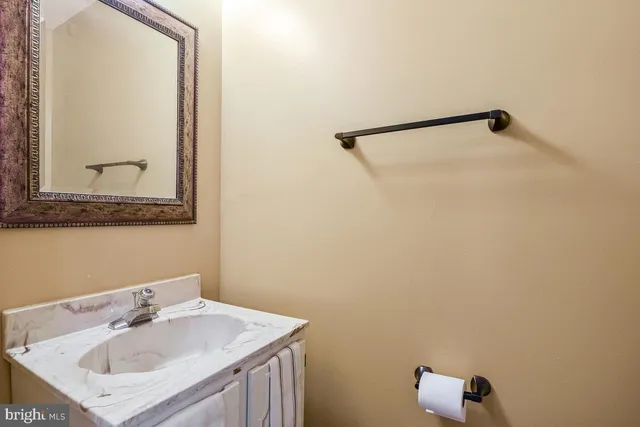 a bathroom with a sink vanity and a mirror