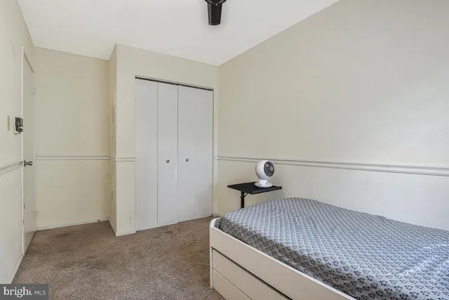 a bedroom with a bed and cabinets