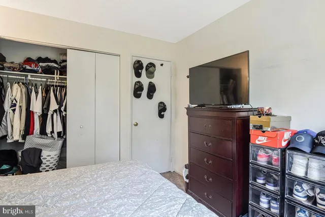 a bedroom with a bed and a television in it