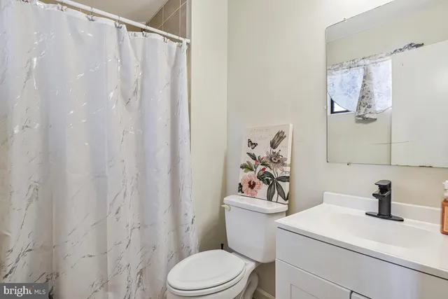 a white toilet sitting next to a bathroom sink