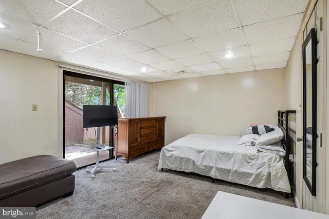 a bedroom with a bed and a couch