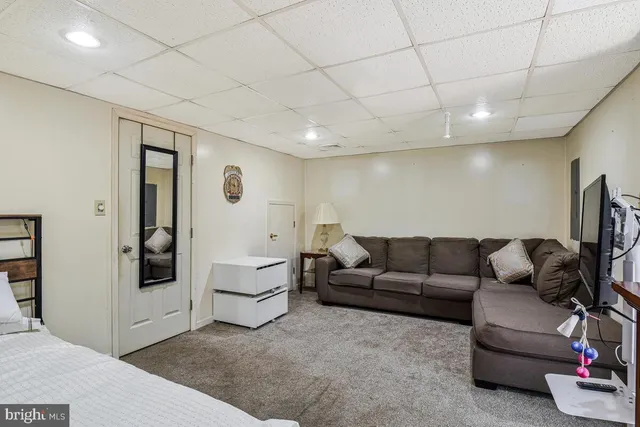 a living room with furniture and white walls