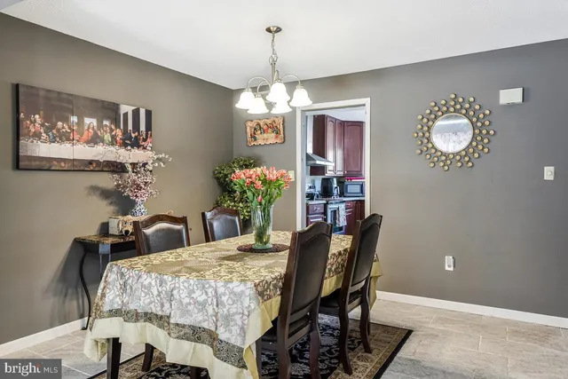 a dining room with furniture and chandelier