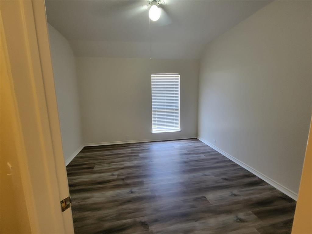 2913 Rush Creek Road McKinney, TX 75072 - Photo 13 of 32 2nd bedroom with walk-in closet and new laminate flooring