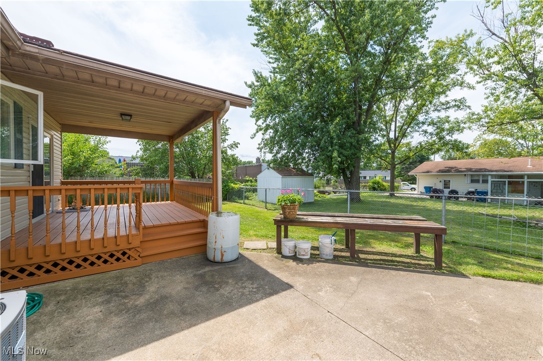 1140 West River Road Vermilion, OH 44089 - Photo 37 of 49 Fenced backyard with a deck, a patio, and a storage shed