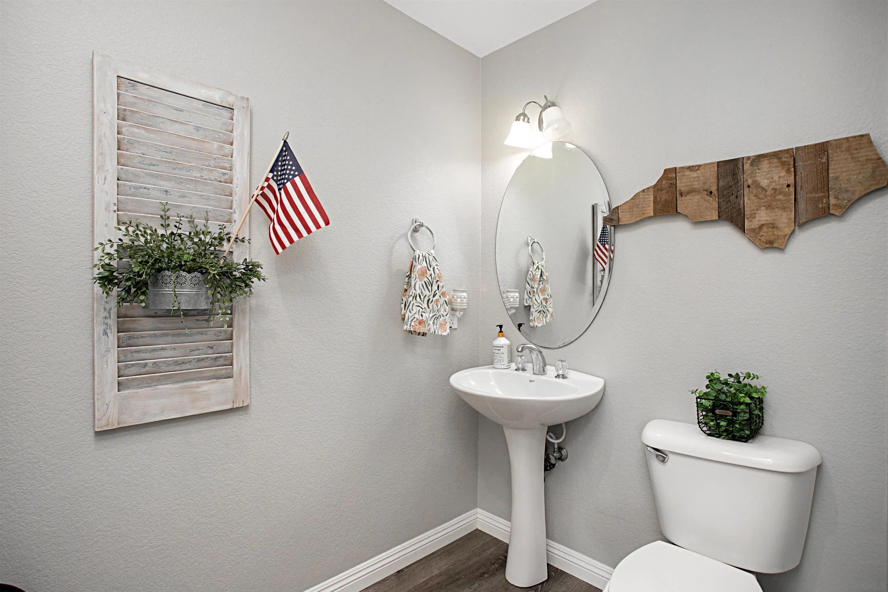 1091 Greenway Road Oceanside, CA 92057 - Photo 12 of 26 a bathroom with a toilet sink and mirror