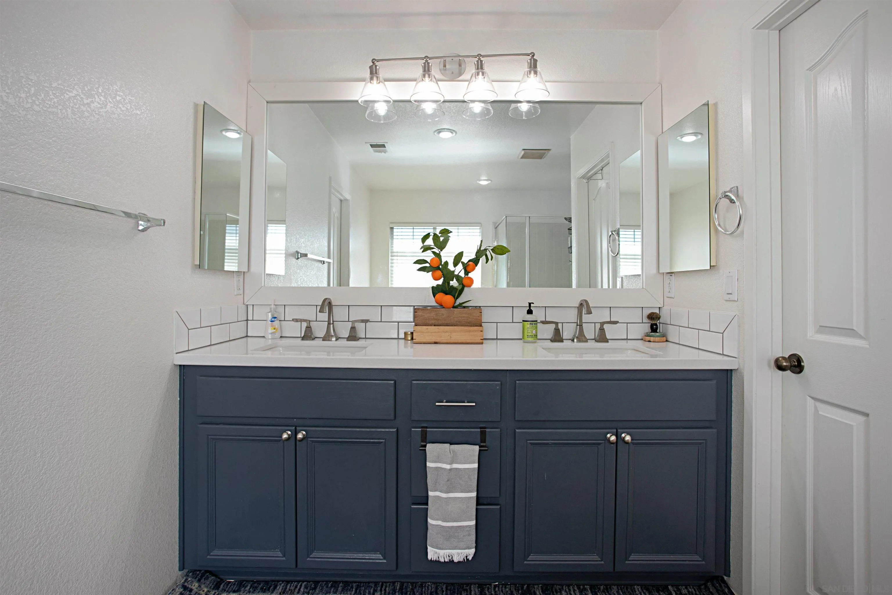 1091 Greenway Road Oceanside, CA 92057 - Photo 16 of 26 a bathroom with a double vanity sink and a mirror