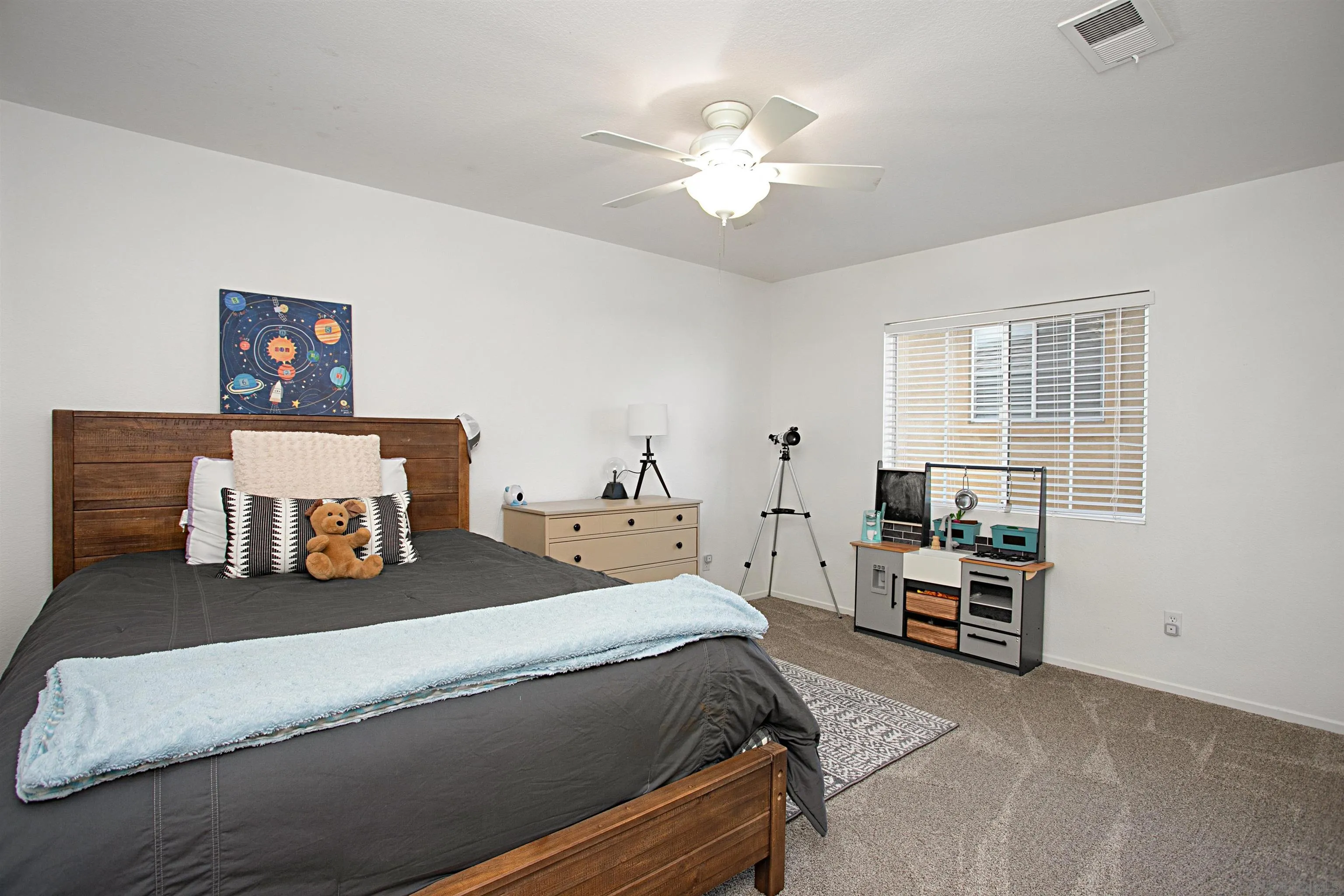 1091 Greenway Road Oceanside, CA 92057 - Photo 20 of 26 a bedroom with a bed and a chandelier