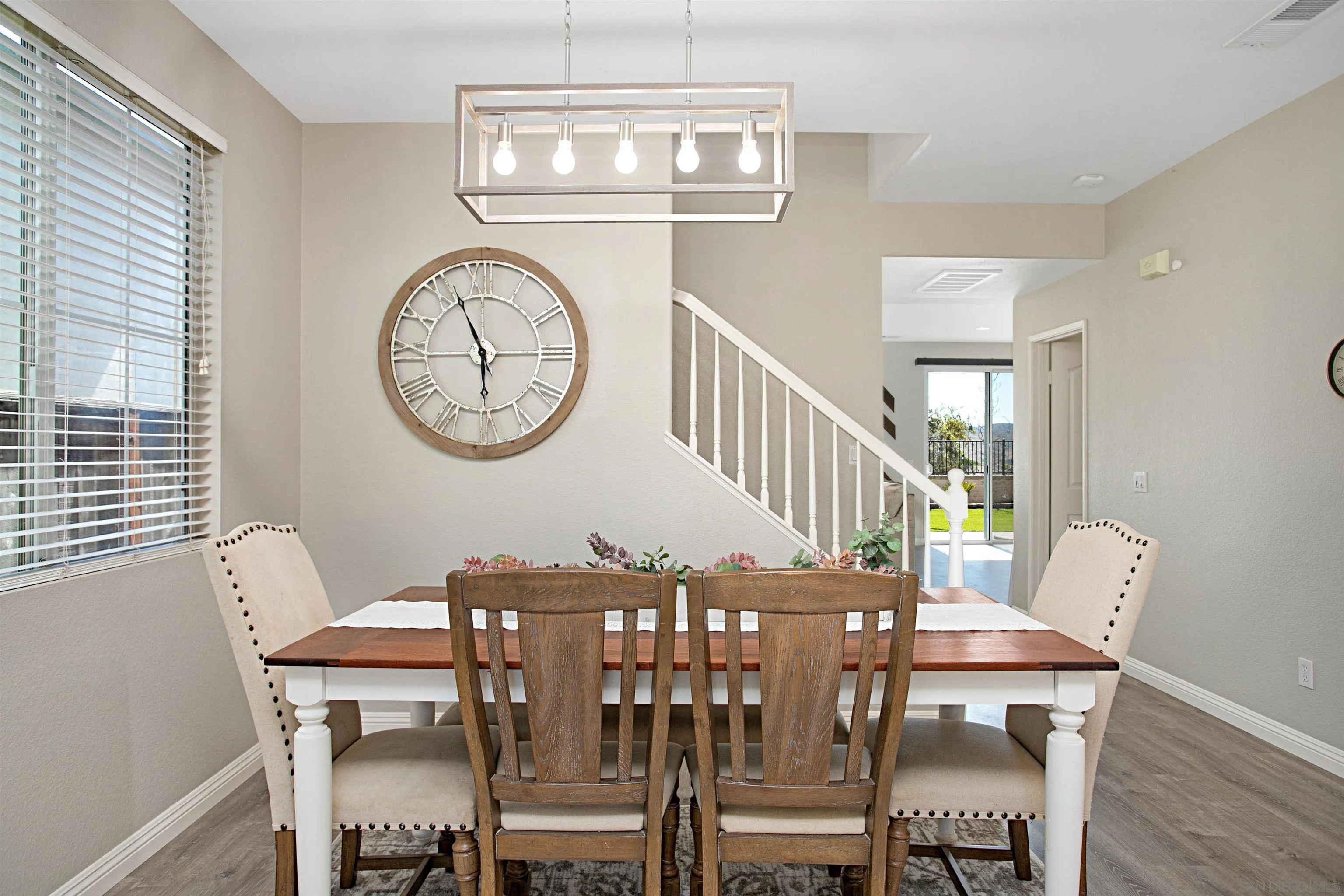 1091 Greenway Road Oceanside, CA 92057 - Photo 6 of 26 a view of a dining room with furniture a chandelier and wooden floor
