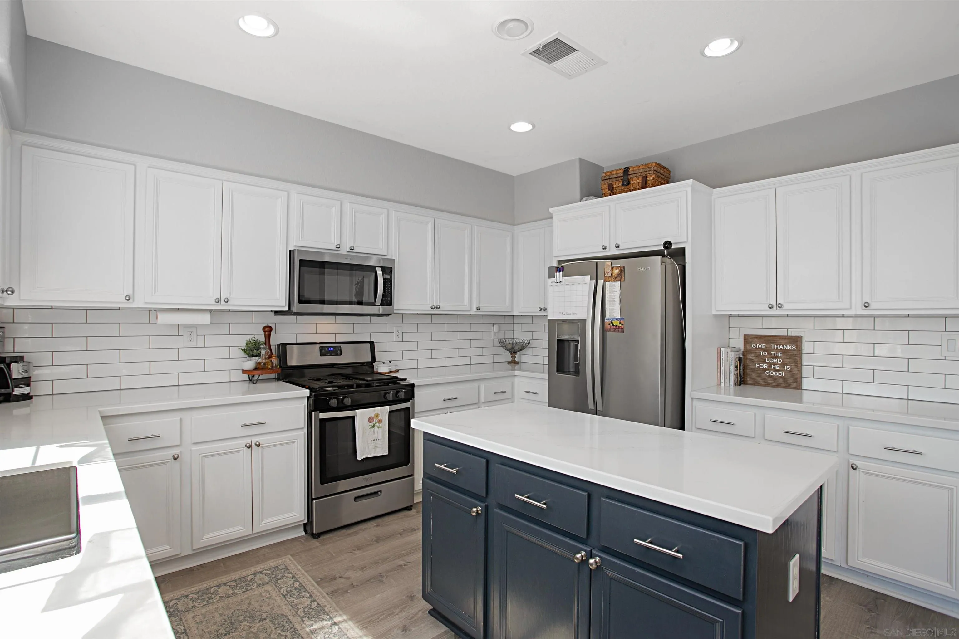 1091 Greenway Road Oceanside, CA 92057 - Photo 9 of 26 a kitchen with a sink stainless steel appliances and white cabinets