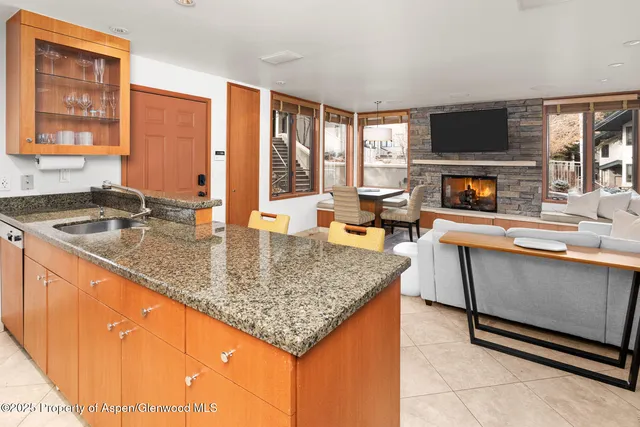 a kitchen with granite countertop a stove and a sink