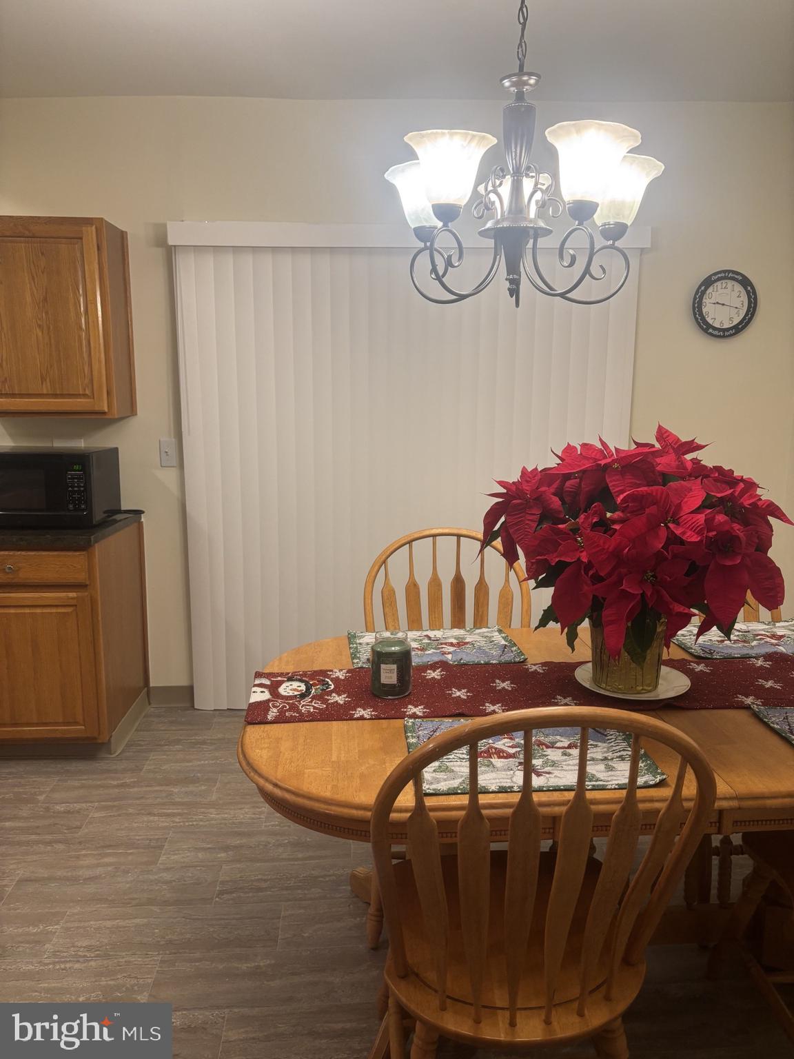 4907 Rawle Street Philadelphia, PA 19135 - Photo 11 of 24 a view of a dining room with furniture a chandelier and wooden floor
