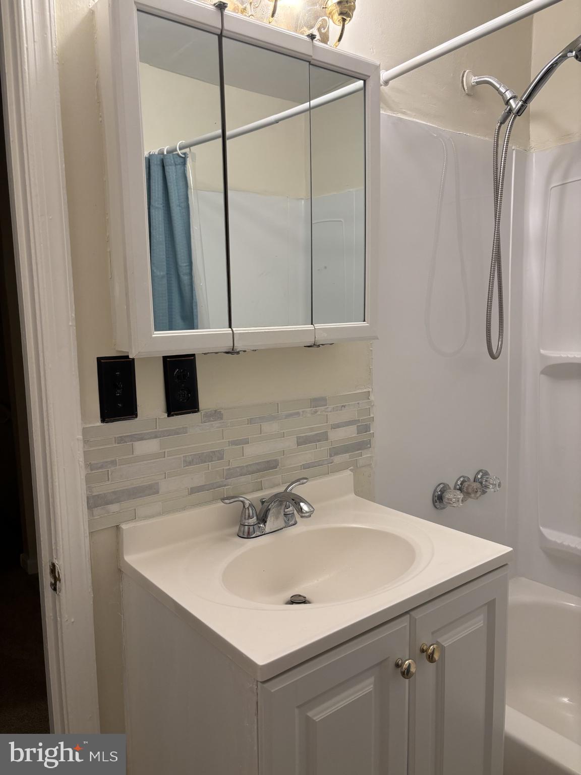 4907 Rawle Street Philadelphia, PA 19135 - Photo 16 of 24 a bathroom with a sink and a mirror
