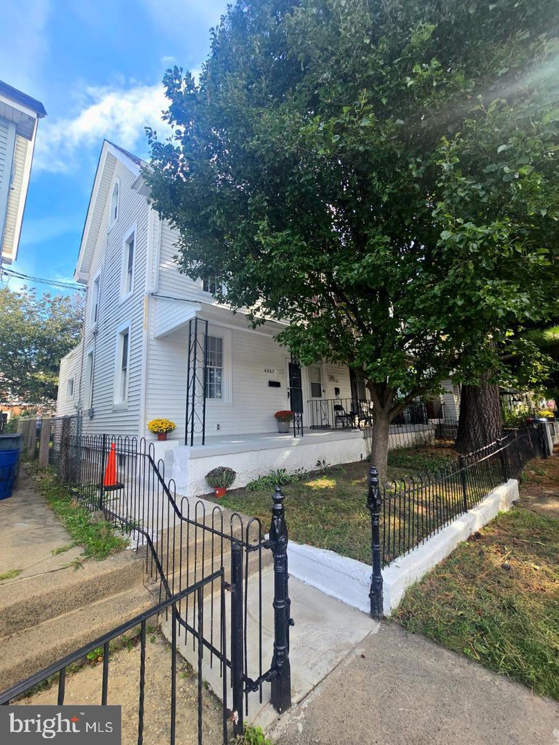 4907 Rawle Street Philadelphia, PA 19135 - Photo 2 of 24 a front view of house with yard and trees in the background