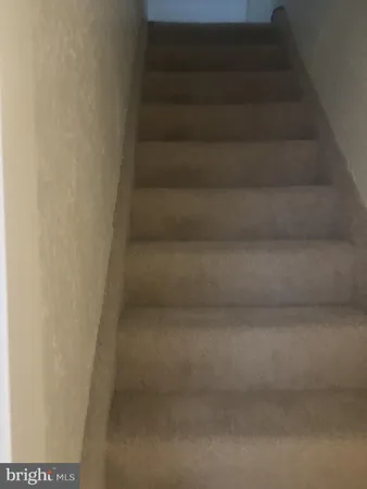 a view of staircase with white walls