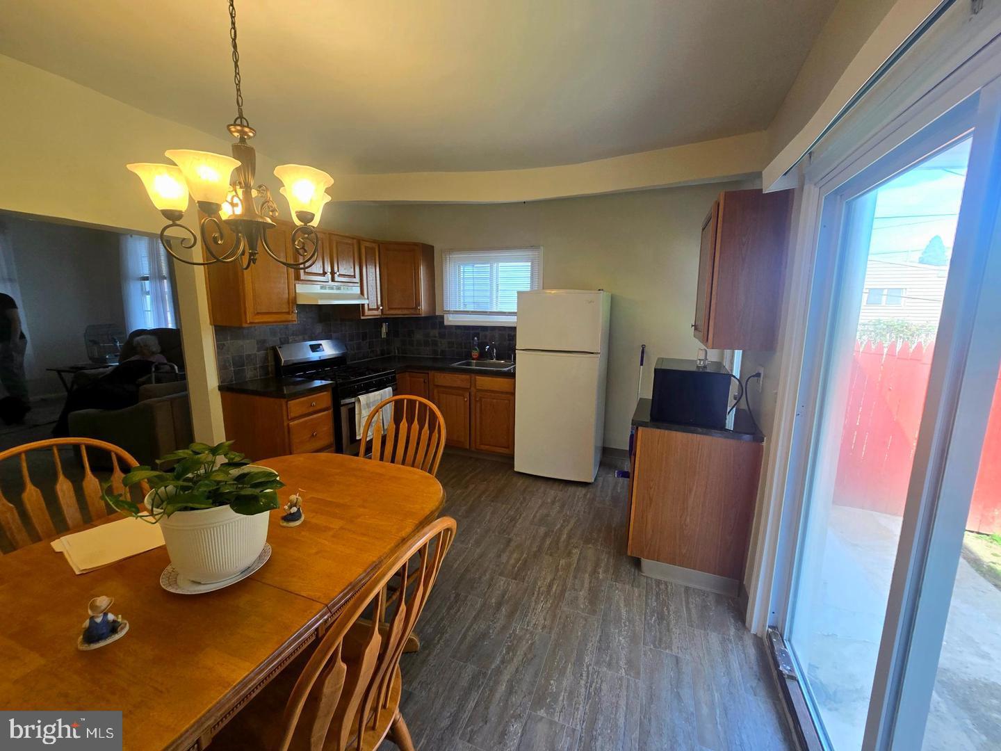 4907 Rawle Street Philadelphia, PA 19135 - Photo 7 of 24 a view of a dining room with furniture and a chandelier