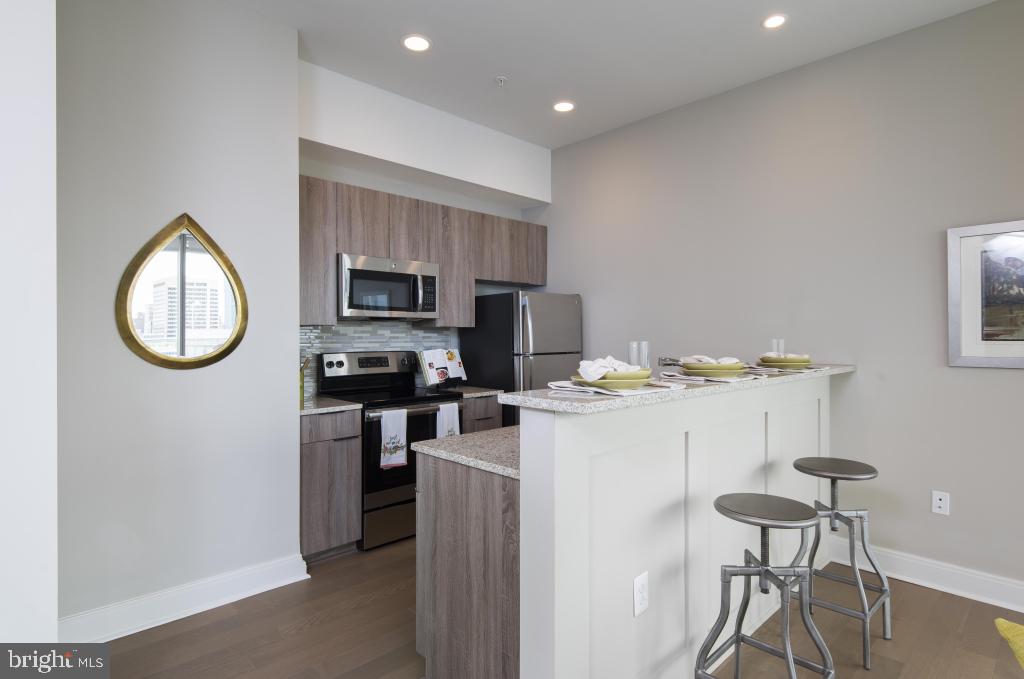 200 North 16th Street, Unit 1624 Philadelphia, PA 19102 - Photo 58 of 66 a kitchen with a refrigerator and a stove top oven