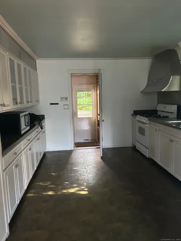 a kitchen with granite countertop a stove and a sink