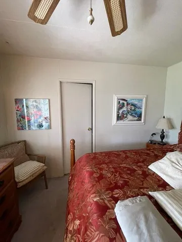 a bedroom with a bed and painting on the wall