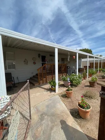 a view of a patio with table and chairs potted plants