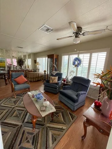 a living room with furniture a couch and a chandelier