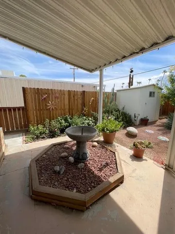 a view of a backyard with plants and patio