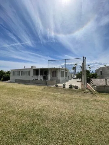 a view of a house with swimming pool and sitting area