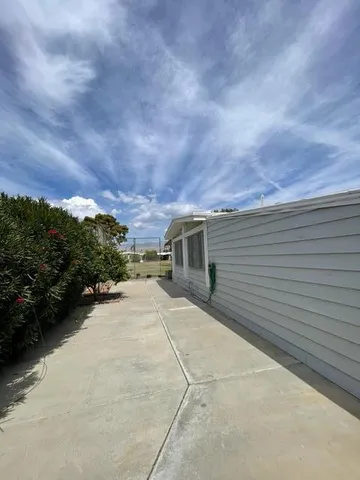 a pathway of a house with a yard