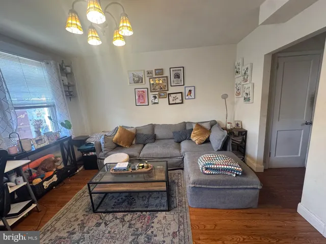 a living room with furniture and a chandelier