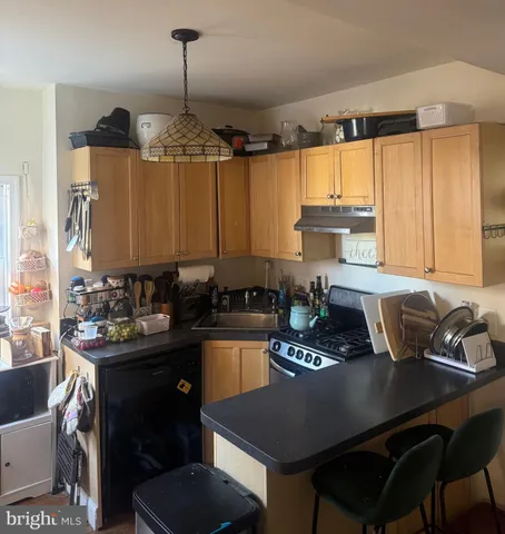 a kitchen with a table chairs stove and cabinets